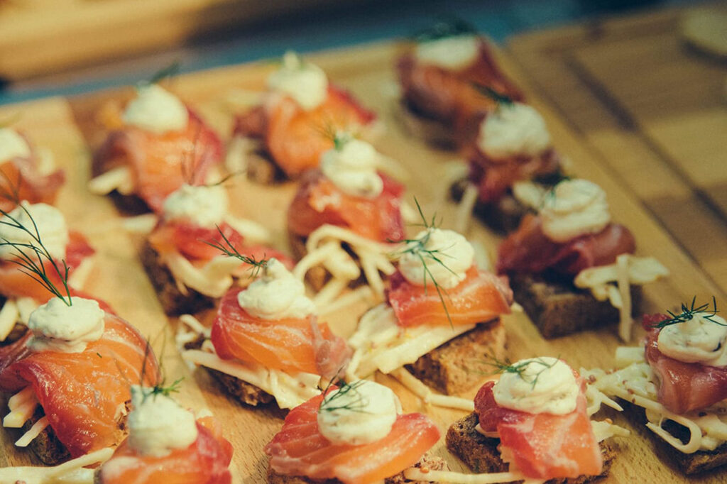 Gravadlax and celeriac remoulade Canapés on a wooden board, served at The York Norwich private dining event.